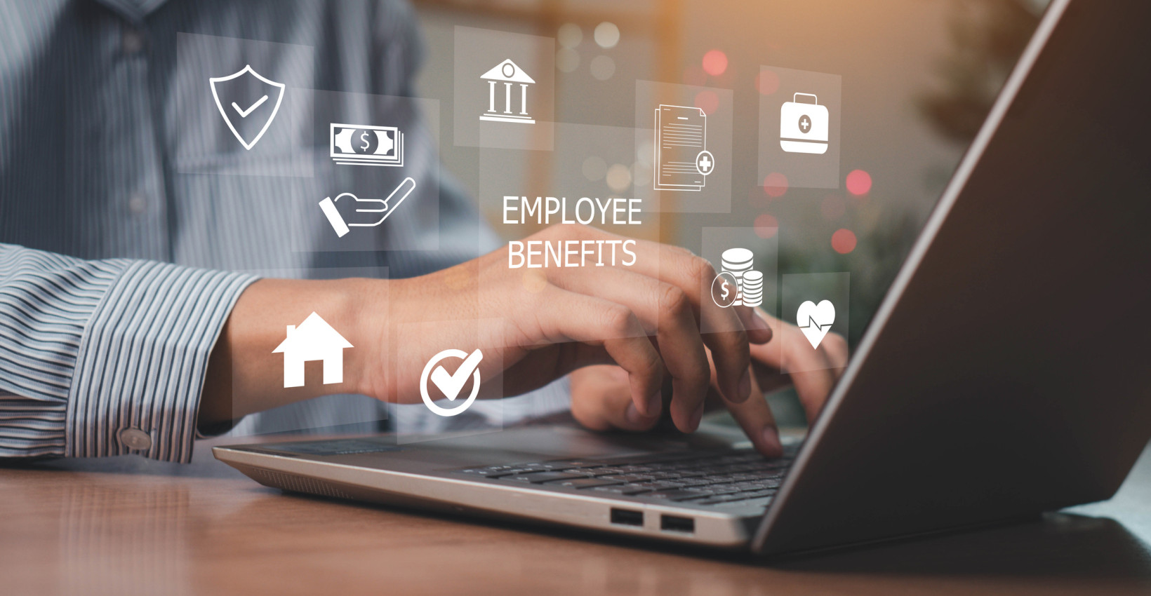 a person works at a laptop with graphics floating around on the image