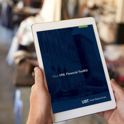 a person holds an ipad with UBT's UNL financial toolkit