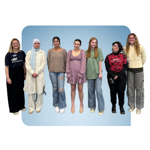 Brittany Planos standing next to six female students