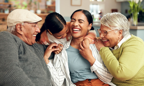 a family sits on a couch laughing