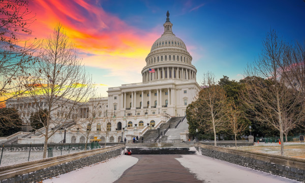 A picture of the US Capitol building at sunset