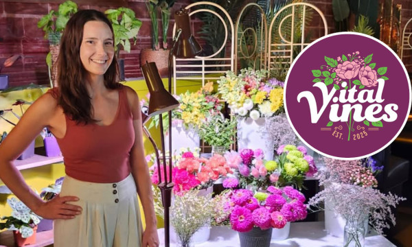 Sydney Vecchio stands in front of plants with the vital vines logo overlayed 